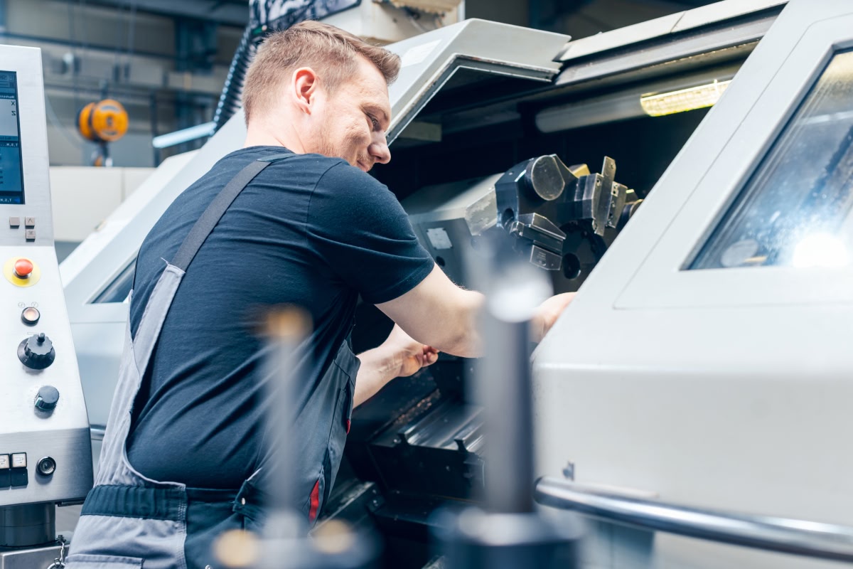 Machinist working at a CNC lathe